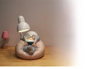 Detail of creative night light featuring a cute elderly figure with headset on a beanbag