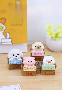 Close-up of four mini resin animals sitting in carton boxes for desk decoration