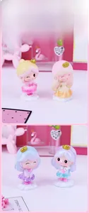 Detailed view of four colorful princess cake toppers with golden crowns on cloud bases