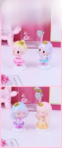 Close-up of colorful resin princess figurines with glossy finish on white cloud bases