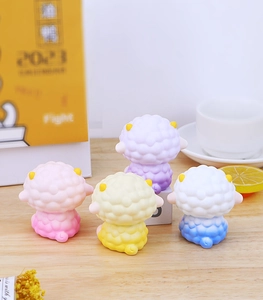 Rear view of four gradient sheep resin figurines in pink, yellow, purple, and blue colors