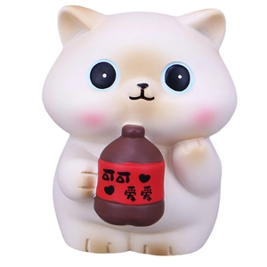 Cute white lucky cat figurine holding a cocoa bottle for desk or car dashboard decoration