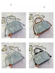 Detail showing various colors of sequin bucket bags with pearl bow and chain strap