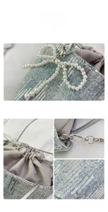 Detail showing sequins on denim fabric with pearl bow charm and drawstring closure