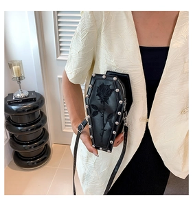 Detailed shot of gothic coffin shoulder bag with rose embroidery and silver metal rivets