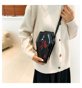 Detailed close-up of coffin-shaped PU leather crossbody bag with red rose and cross embroidery