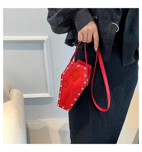 Detail of red coffin-shaped gothic bag with rose embossing and silver studs