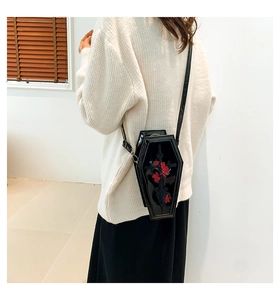 Detail of cross and red rose embroidery on a black coffin-shaped gothic PU crossbody bag