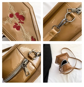 Detail of gothic coffin-shaped PU leather bag with rose and cross embroidery