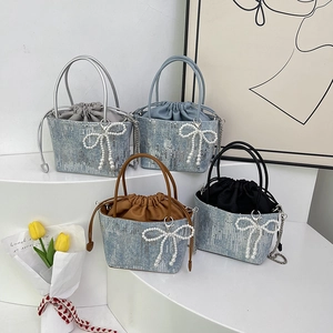 Sequin bucket bags with pearl bow charms and drawstring liners in four trendy colors