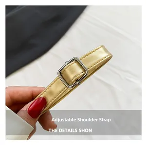 Close-up of adjustable champagne gold leather strap with metallic texture and silver buckle
