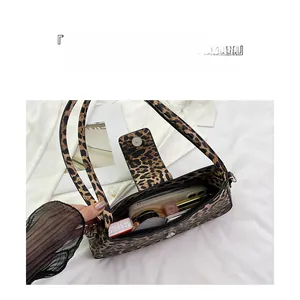 Internal view of leopard print bag showing storage capacity for phone and cosmetics