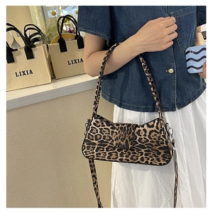 Detail of leopard print underarm bag with metal buckle and adjustable shoulder strap