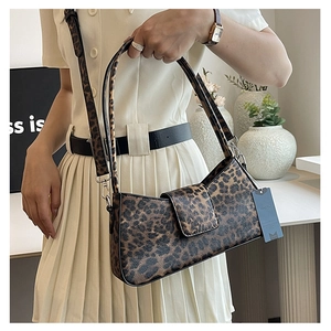 Fashionable leopard print underarm bag with silver hardware and adjustable shoulder strap