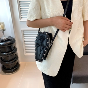 Gothic coffin-shaped crossbody bag with rose embroidery and silver rivet accents