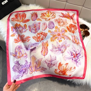 Floral print square silk scarf with tulips and lilies displayed on a plush background