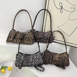 Leopard print underarm bags in four colors displayed on white stairs for a trendy look