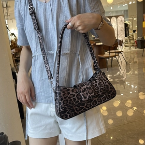 Leopard print underarm bag with adjustable crossbody strap and silver metal buckles