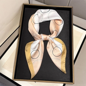 Detail van elegante zijdeachtige sjaal met geometrisch patroon en gele rand