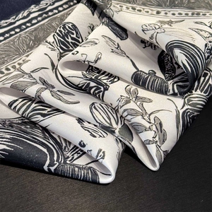 Macro detail of the silk-satin scarf fabric showing elegant botanical flower patterns