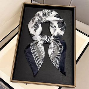 French style silk scarf with butterfly print and blue chain border on a display tray
