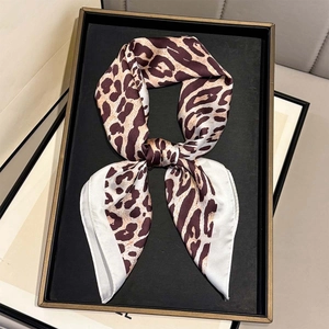 Classic leopard print satin silk scarf with white borders on a black display tray