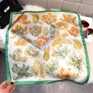 Floral print square silk scarf with tulips and green borders on soft plush background