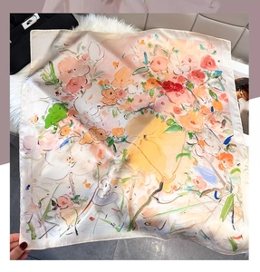 Detailed view of square silk scarf with oil painting floral prints on a textured backdrop