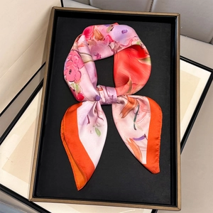 Detail of silk-like scarf featuring abstract oil painting flowers and orange rolled edges