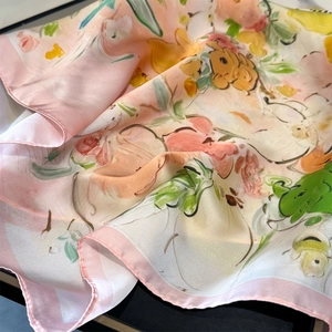 Detailed view of pink oil-painting floral silk scarf with soft satin texture and rolled hem