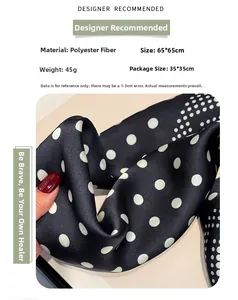 Detailed view of black polka dot silk scarf in polyester with smooth satin texture