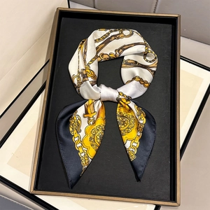 Luxury silk square scarf with vintage chain print and gold accents in a knotted style
