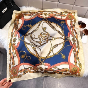 Luxury silk square scarf with vintage chain print shown with elegant fashion accessories
