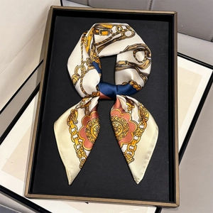 Detail of silk scarf with vintage chain and buckle print in an elegant display