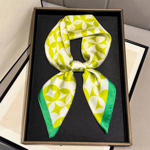 Elegant green floral square silk scarf for women displayed in a stylish bow arrangement