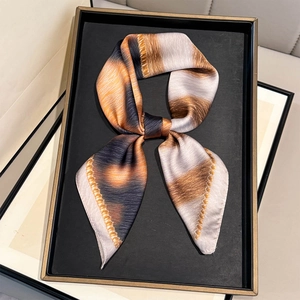 Leopard stripe print square neck scarf tied in a bow on a black display tray
