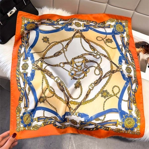 Orange square silk scarf with vintage luxury chain print on a soft plush background