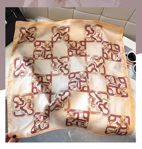 Detail of silk square scarf featuring vintage rose print and geometric chain patterns