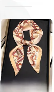 Detail view of a vintage geometric chain silk scarf neatly folded on a black velvet tray
