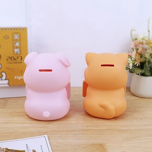 Detail view of the coin slot on back of cute animal piggy banks for kids