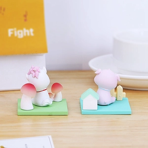 Detailed back view of miniature resin animal figurines on a wood grain tabletop