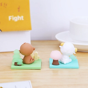 Miniature animal figurines on green lawn bases with tiny trees for desk decoration