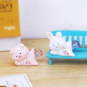 Cute pig and rabbit decorative figurines with heart accents on a wooden desktop