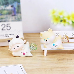 Detail view of cute resin night lights featuring sheep and puppy shapes on wooden desk