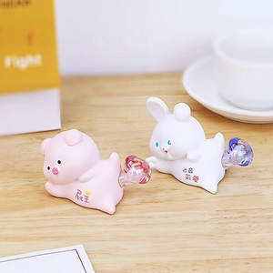 Detail view of cute pig and rabbit night light ornaments with crystal tail accents