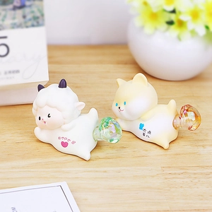 Macro detail of cute animal figurines with rainbow tail glass balls on wooden surface
