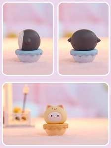 Detail of cute penguin and cat tumbler figurines in a cozy miniature desktop setting