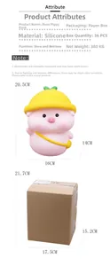 Pink vinyl piggy bank with yellow hat shown alongside its compact cardboard packaging box