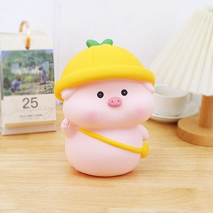 Cute pink pig piggy bank with yellow hat and bag on desk as decorative gift