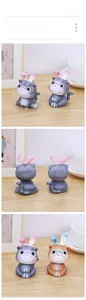 Close-up of cat resin figurines with rabbit ears and glasses for desktop decor